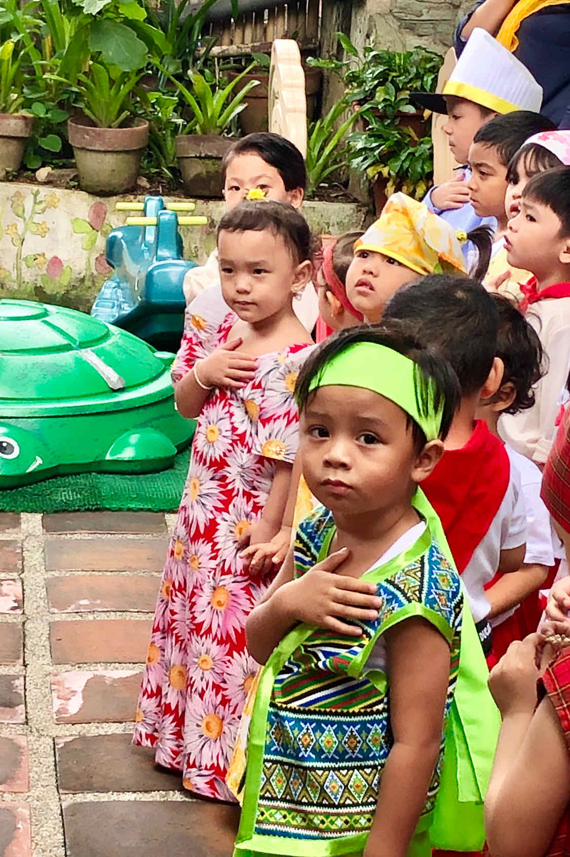 Young Filipino boy with hand on his heart to show patriotism during the Philippine National Anthem